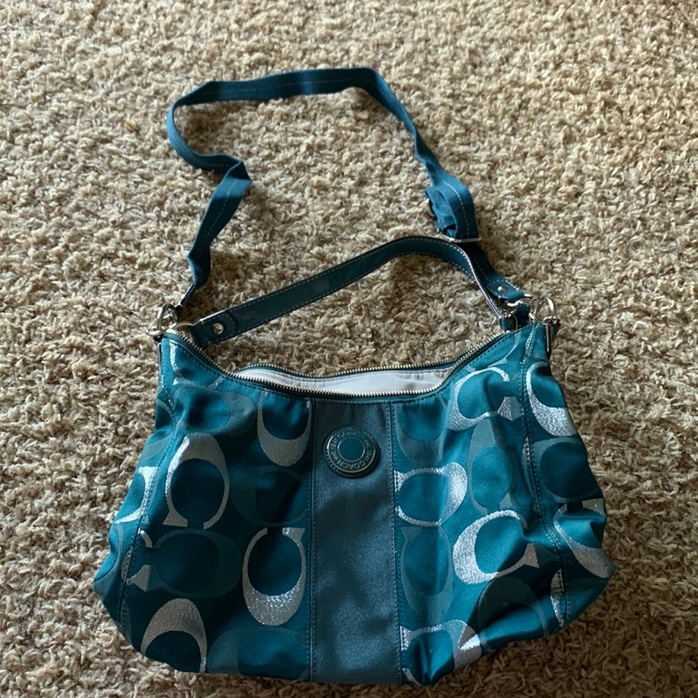 Turquoise and silver coach purse.